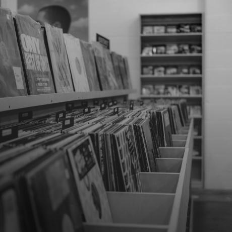 A black and white photo of a record store.