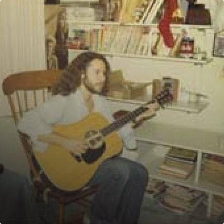 Jon Thomas is playing guitar.