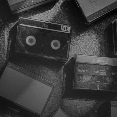 A black and white photo of a group of cassettes.