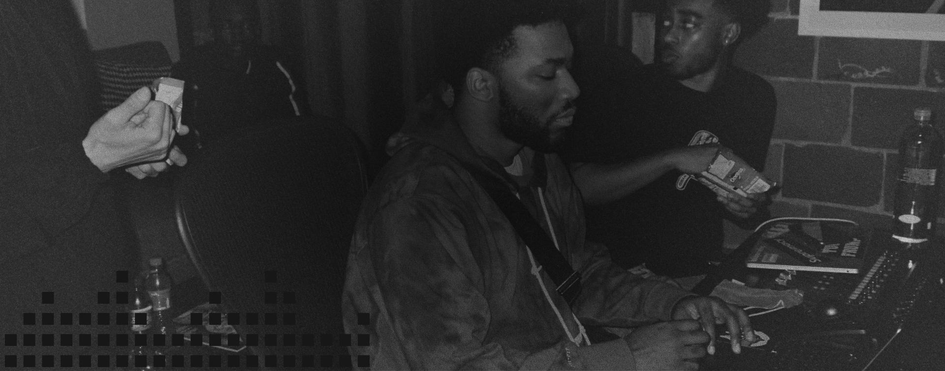 Black and white photo of two men in a recording studio.